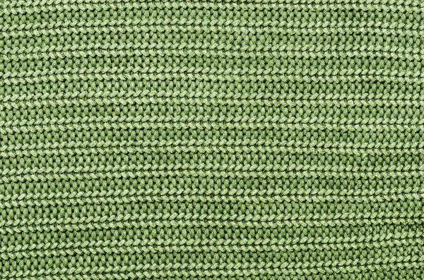 Закрыть зеленый вязаный пуловер фон — стоковое фото