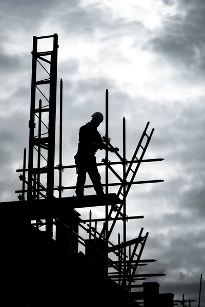 Builder on scaffold building site Stock Image