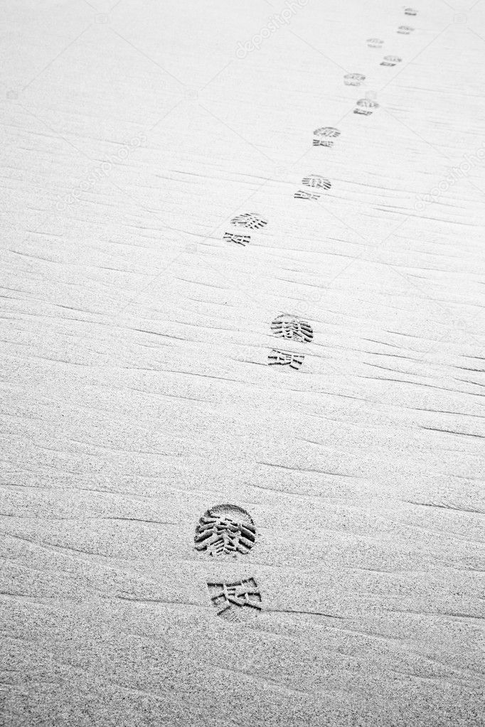 Footprint of hiking shoe on beach