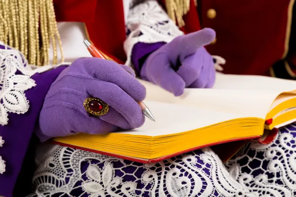 Hands of sinterklaas with book — Stock Photo, Image