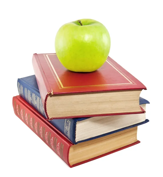 Apple on top of stack of old books — Stock Photo, Image