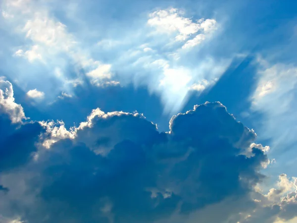 Blue sky with sun rays through the clouds — Stock Photo, Image