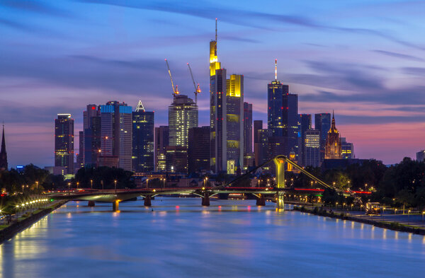 Night view on the Frankfurt skyline with reflections on water