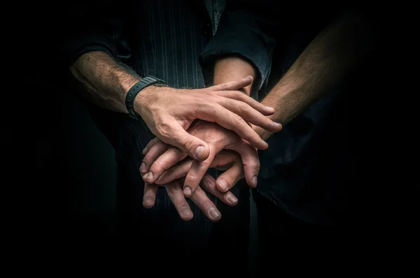 Group of young adults making a pile of hands — Stock Photo, Image