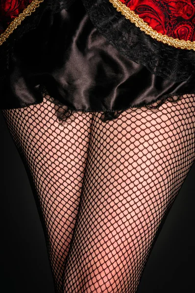 Legs of a youn woman against dark background — Stock Photo, Image