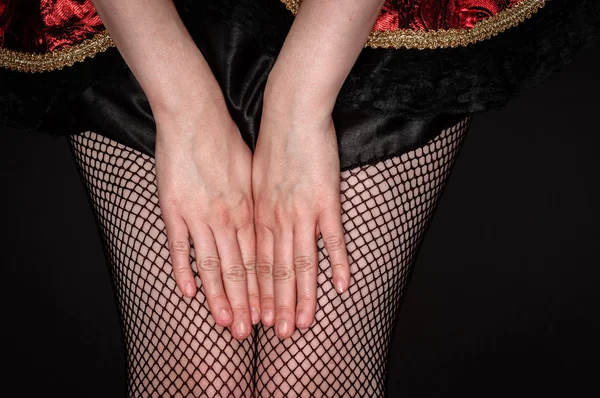 Legs of a youn woman against dark background — Stock Photo, Image