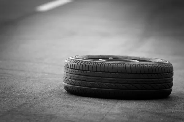 Car tire on the road — Stock Photo, Image