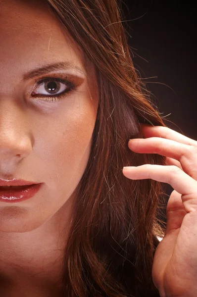 Young woman against dark background — Stock Photo, Image