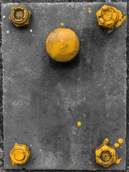 Yellow screws on grey metal plate — Stock Photo, Image