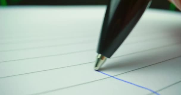 Probe lens following head of pen drawing a line — Stock Video