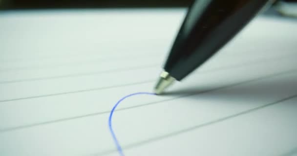 Probe lens following head of pen drawing a line — Stock Video