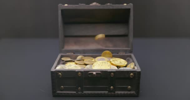 Money falling into treasure chest in slow motion — Stock Video