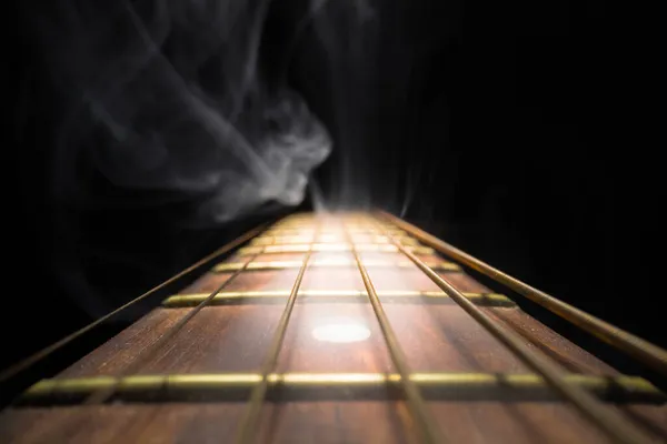 Guitar fretboard against dark background — Stock Photo, Image