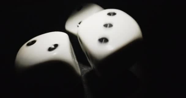 Plastic playing gambling dice rolling forever against dark background — Stock Video