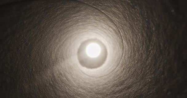 Camera movement in long illuminated tunnel with light at the end — Stock Video