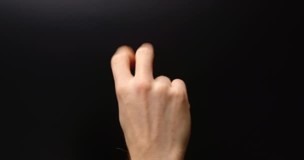 Man shoving several hand gestures against dark background — Stock Video