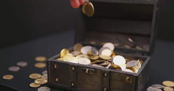 Money falling into treasure chest in slow motion — Stock Video