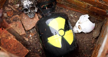 Nuclear waste between skulls close up clipart
