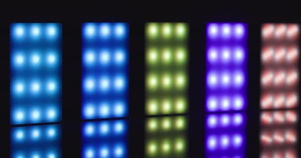 Colorful led lights lined up against dark background — 图库视频影像