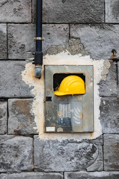 Safety helmet against concrete wall close up photo