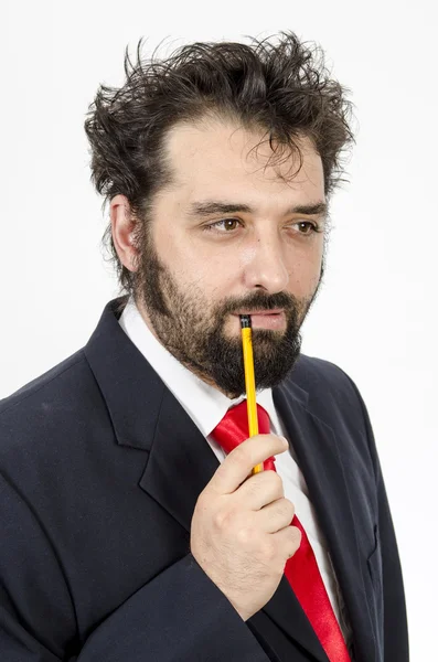 Businessman in red tie with a pencil — Stock Photo, Image