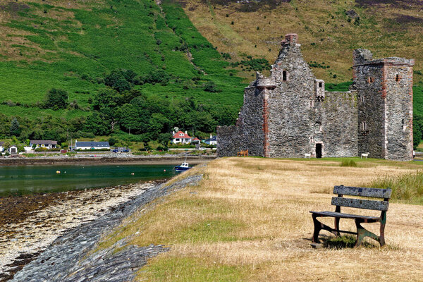 The ruin of Lochranza Castle in the middle of Lochranza on the Isle of Arran. Lochranza , Arran, North Ayrshire, Scotland - 21st of July 2021