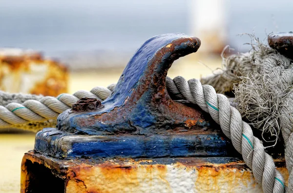 Close up of the boat bollard with a rope tied around it. Connection visual concept as boat tied and linked to the pontoon