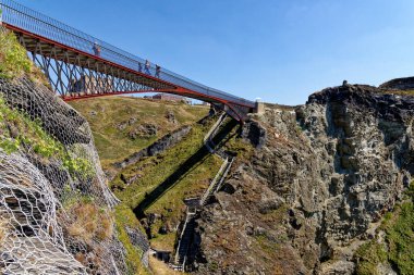 The Tintagel Bridge opened in 2019 connects the mainland with the island where the Arthurian Legend of Camelot was imagined. Tintagel castle, Cornwall, England, United Kingdom - 12th of August 2022