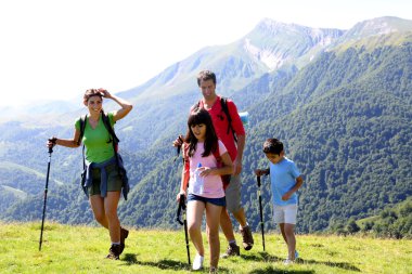 Family on a trekking day in the mountains clipart