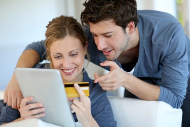 Young couple at home buying on internet