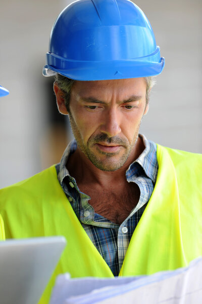 Closeup of construction manager checking plan