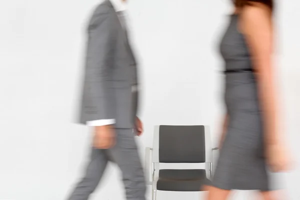 Business walking by chair set in hallway — Stock Photo, Image