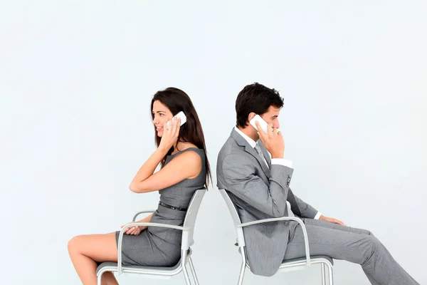 Business sitting in chairs with mobile phone — Stock Photo, Image