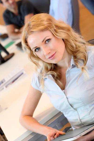 Beautiful office worker using tablet in office — Stock Photo, Image