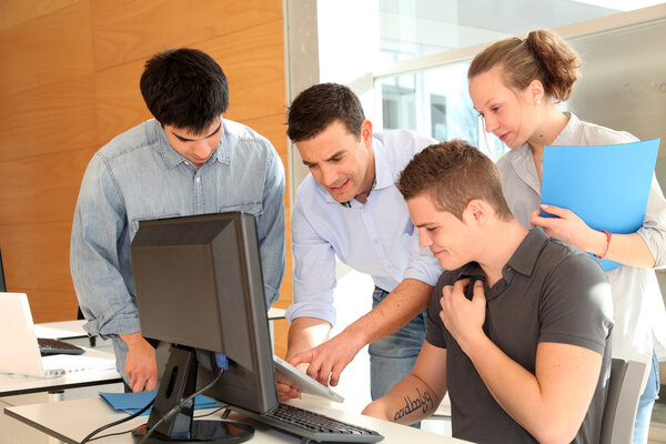 Teacher with group of students in class