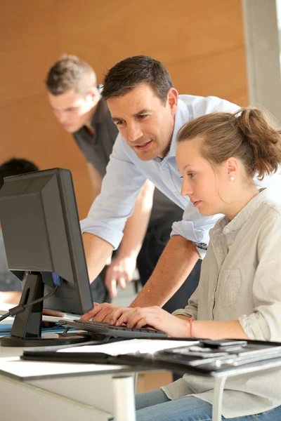 Teacher helping student girl with project — Stock Photo, Image