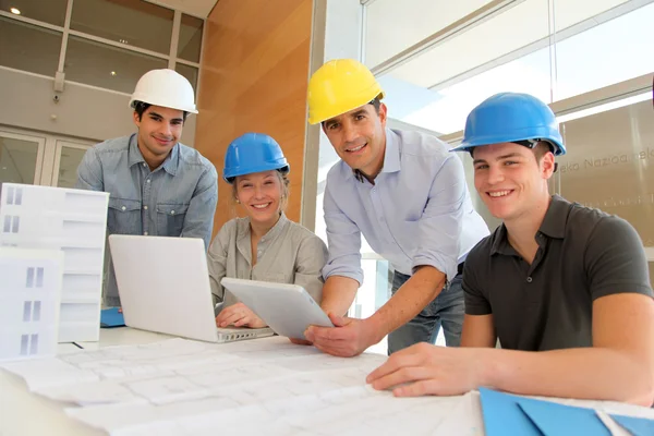 Pädagoge mit Architekturstudenten, die an einem elektronischen Tablet arbeiten — Stockfoto