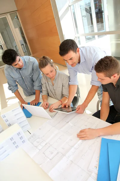 Educador con estudiantes de arquitectura trabajando en tableta electrónica —  Fotos de Stock