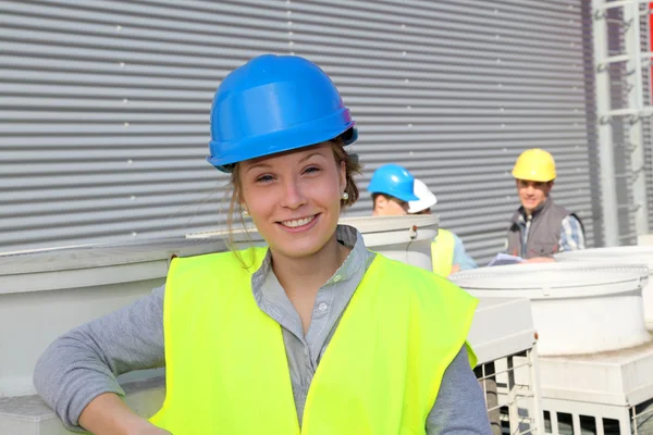 Portrait of smiling student girl in professional training — Stock Photo, Image