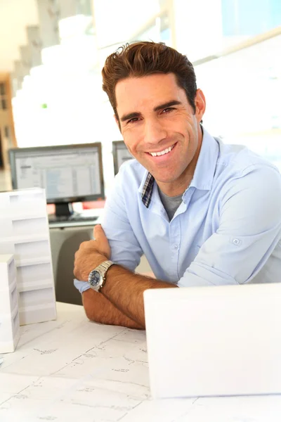 Smiling architect sitting in office — Stock Photo, Image