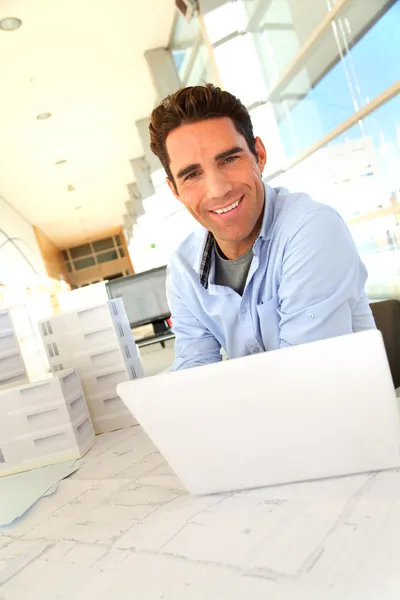 Smiling architect sitting in office — Stock Photo, Image