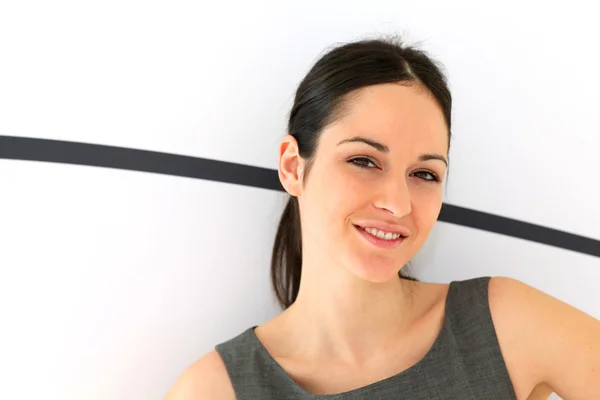 Young active businesswoman standing in hall — Stock Photo, Image