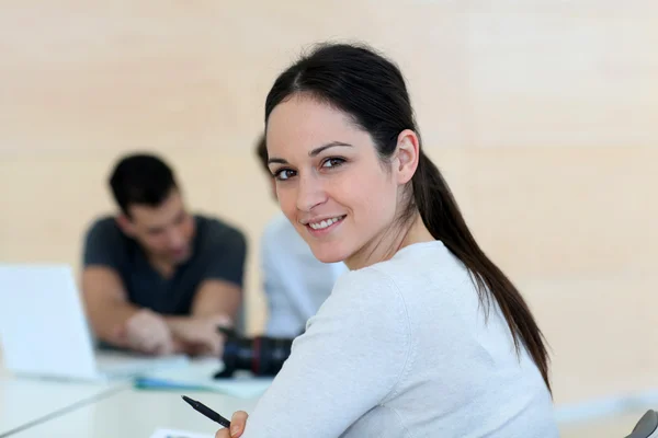Jovem sorrindo mulher em reunião de trabalho — Fotografia de Stock