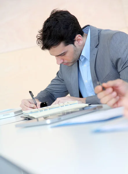 Young man filling in application form — Stock Photo, Image