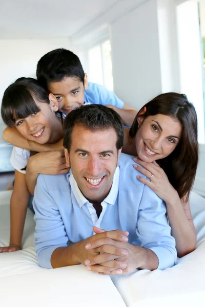 Retrato de família feliz deitado cama — Fotografia de Stock