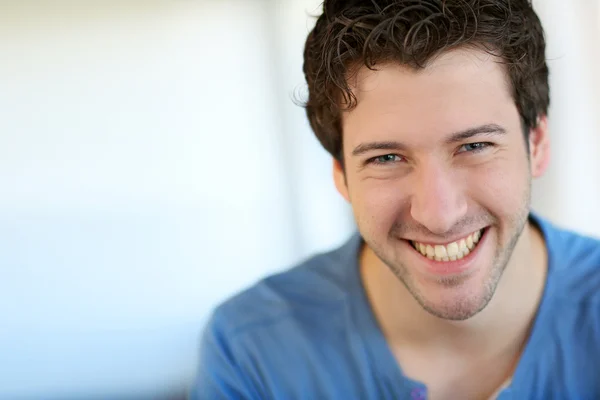 Portrait of cheerful young guy with blue eyes — Stock Photo, Image