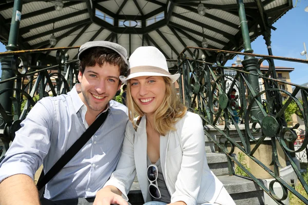 Romantisch paar zitten door gazebo op toeristisch gebied — Stockfoto