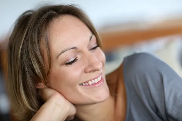 Portrait of middle-aged woman relaxing in sofa — Stock Photo, Image