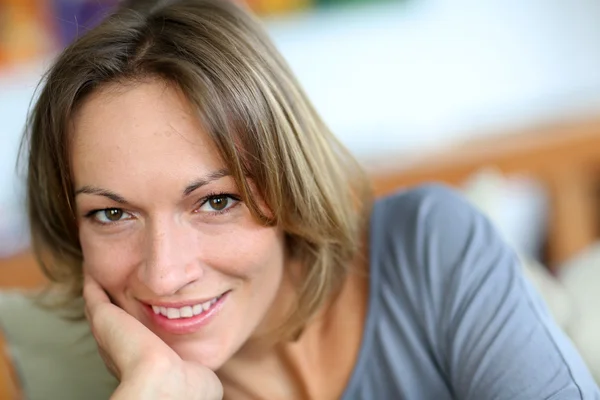 Portrait of middle-aged woman relaxing in sofa — Stock Photo, Image