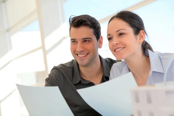 Happy young couple signing property purchase contract Stock Image